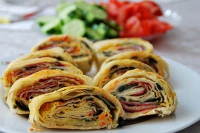 <p><font face="verdana,geneva" size="2">* Sulu har&ccedil;tan s&uuml;r&uuml;p pazılı karışımı yayın. <br />* Tekrar son yufkayı serip ıslattıktan sonra pastırma dilimlerini yerleştirin. <br />* Yufkanın bir ucundan tutarak sıkıca rulo şeklinde sarın. <br />* Ortadan ikiye b&ouml;l&uuml;p yağlanmış tepsiye yan yana yerleştirin. <br />* &Uuml;st&uuml;ne yumurta sarısı s&uuml;r&uuml;l&uuml;p susam serperek 170C dereceli fırında pişirin. <br />* Dilimleyerek servis yapın. Afiyet olsun</font></p>