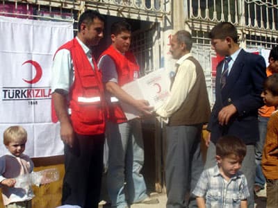 <strong><font face="Arial" size="2">Bağışlarda B&uuml;y&uuml;k D&uuml;ş&uuml;ş Yaşandı<br /><br /></font></strong><font face="Arial" size="2">Kısa mesajla yapılan bağışlardan 'Hazine Payı Kesintisi' 2008 Şubat ayında başlatıldı. Bundan dolayı, 'Ter&ouml;rle M&uuml;cadele Kahramanlarına Destek Kampanyası' ile Kimse Yok Mu gibi derneklere gelen kısa mesajlı bağışlarda b&uuml;y&uuml;k bir d&uuml;ş&uuml;ş yaşandı. Hazine M&uuml;steşarlığı, tepkiler &uuml;zerine cep operat&ouml;rlerine bir yazı g&ouml;ndererek bağışlar &uuml;zerindeki y&uuml;zde 15'lik hazine kesintisinin iptal edildiğini bildirdi. Ancak yazıya 'Telekom&uuml;nikasyon Kurumu'nun (TK) uygun g&ouml;rmesi halinde' ibaresi not d&uuml;ş&uuml;ld&uuml;ğ&uuml; i&ccedil;in sorun &ccedil;&ouml;z&uuml;lemedi. TK'den de bu konuda hen&uuml;z bir ses &ccedil;ıkmadı. Bu sebeple SMS'li bağışlar &uuml;zerinden kesinti devam ediyor.<br /><br /></font><font face="Arial" size="2"><strong><br /><br />Ticarete Değil Bağışa Aracılık Ediyoruz<br /><br /></strong></font><font size="2"><font face="Arial"><font color="#333399">'Ticarete değil, bağışa aracılık ediyoruz'</font> tepkisini g&ouml;steren &uuml;&ccedil; GSM şirketi ile yardım dernekleri, bir mesaj karşılığı 75 YKr hazine payı &ouml;demeye karşı &ccedil;ıkıyor. Şirketler ve dernek yetkilileri uygulamanın iptali i&ccedil;in Hazine M&uuml;steşarlığı ve TK'ye defalarca başvuruda bulundu. Ancak sorun &ccedil;&ouml;z&uuml;lemeyince operat&ouml;rler, derneklerle olan anlaşmalarını iptal etmeye başladı. Turkcell aboneleri, bir aydır Kimse Yok Mu Derneği'ne kısa mesaj ile bağış yapamıyor. Şirket, &ouml;n&uuml;m&uuml;zdeki g&uuml;nlerde Kızılay ve diğer yardım derneklerinde s&ouml;zleşmelerine de son verecek. Avea, hazine kesintisini derneklere yapılan 5 YTL'lik bağıştan d&uuml;ş&uuml;yor. Vodafone ise farklı bir form&uuml;lle bağışları derneklerin gelirinden kesinti yapmadan s&uuml;rd&uuml;r&uuml;yor.</font></font>