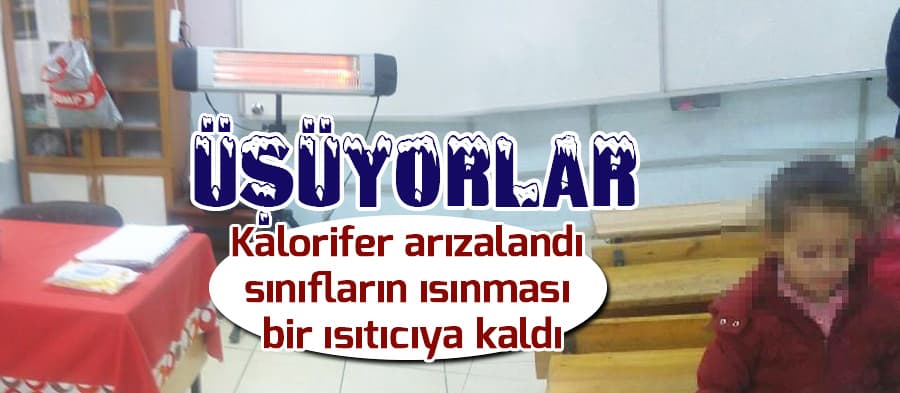 Sınıfta velilerin aldığı ısıtıcılarla ders işliyorlar
