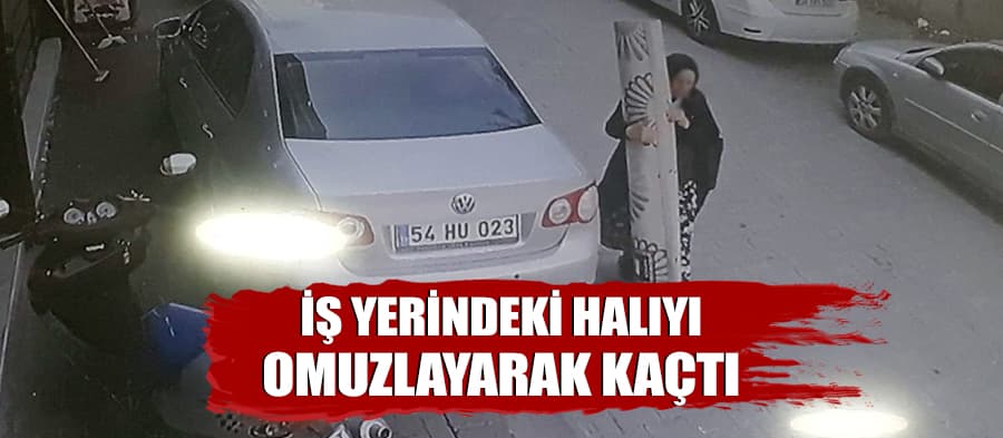 İş yerinin önündeki halıyı omuzlayarak kaçtı